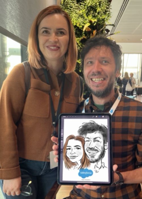 Couple holding their joint live caricature on an iPad