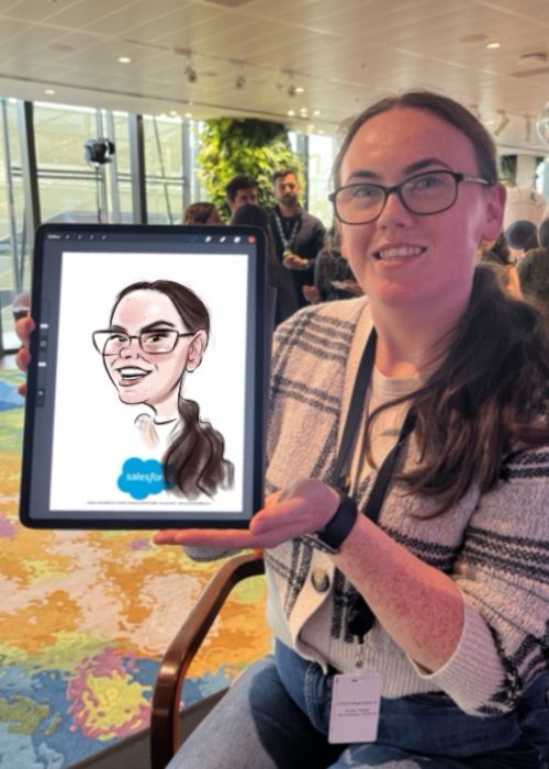 Guest smiling with her live caricature at a corporate event