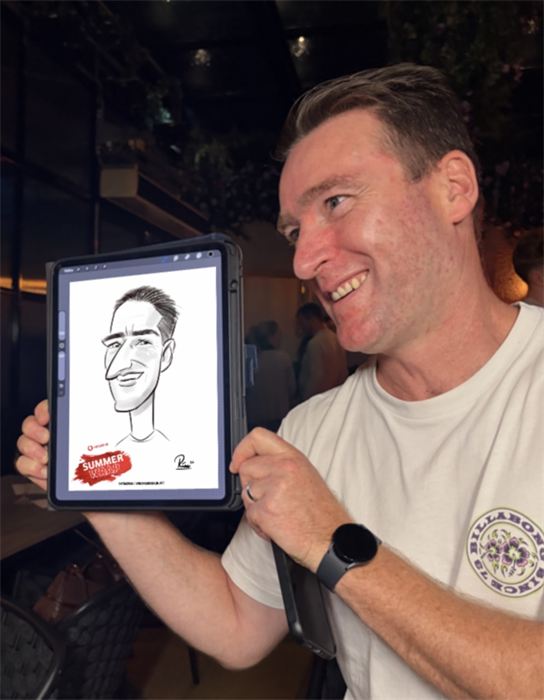 Guest grinning at his live digital caricature at a summer party