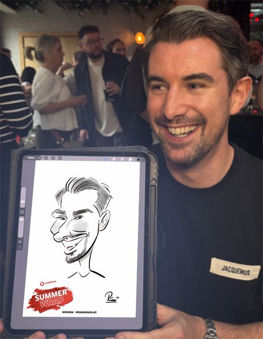 Guest laughing with his live caricature at a summer party