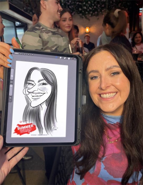 Guest smiling with her live caricature at a summer party