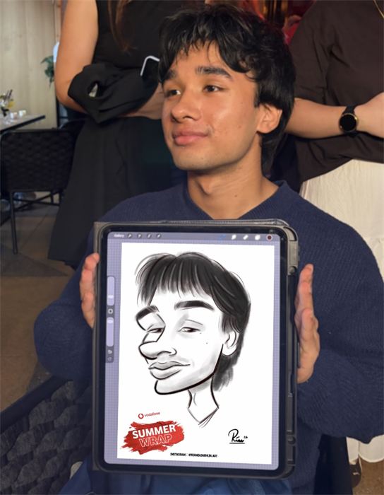 Young guest holding his live digital caricature